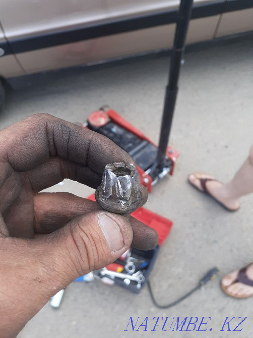 Offsite mobile tire service. Unscrew the torn bolt and lock nut Astana - photo 1