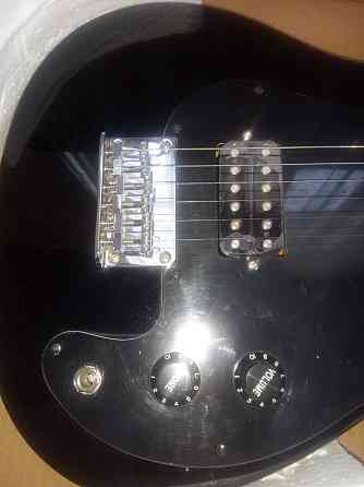 Продам электронную гитару Симекс. Новая, черного цвета, в упаковке. Шымкент